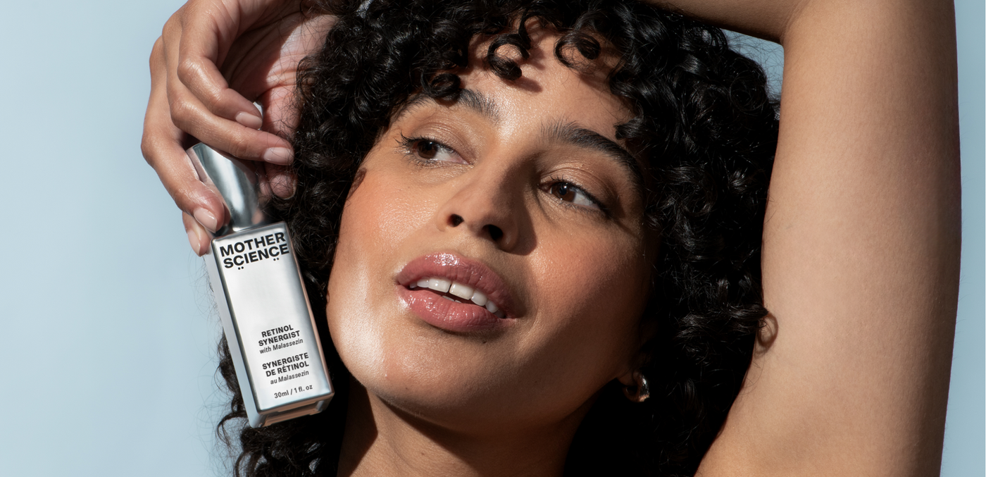 Woman holds bottle of Mother Science Retinol Synergist Encapsulated retinol